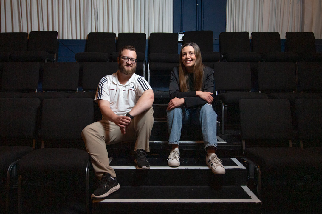 Drama alumni seated in Henry Woolf Theatre